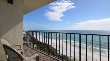 A balcony with a view of the ocean and beach.