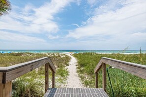 A wooden pathway leading to a beach with a clear sky. - 2BR Beachfront Townhome on PCB West End + Free Tix: Dolphin Cruise & More! (Panama City Beach)