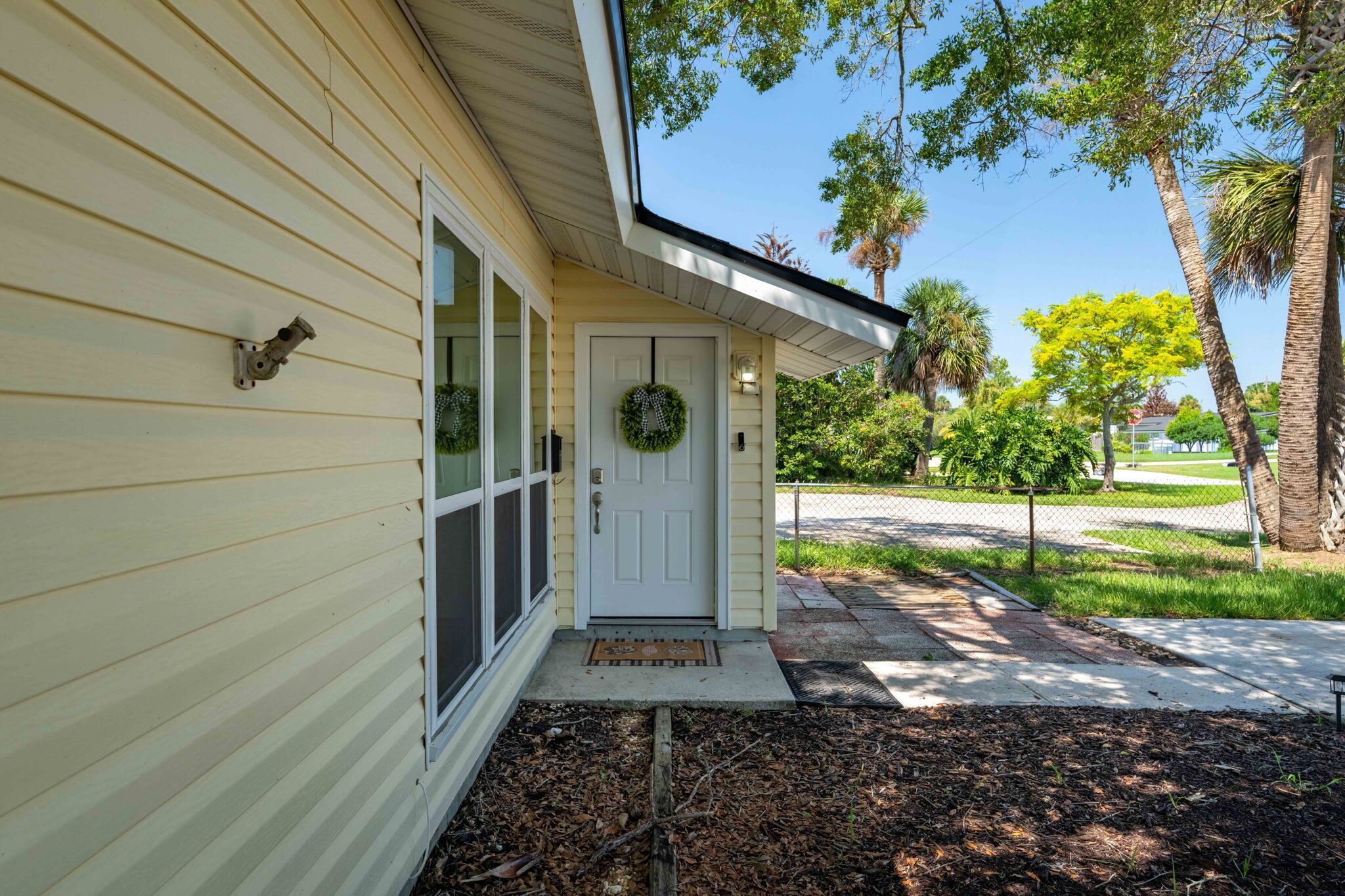 A house with a front door, a window, and a porch.