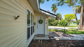 A house with a front door, a window, and a porch.