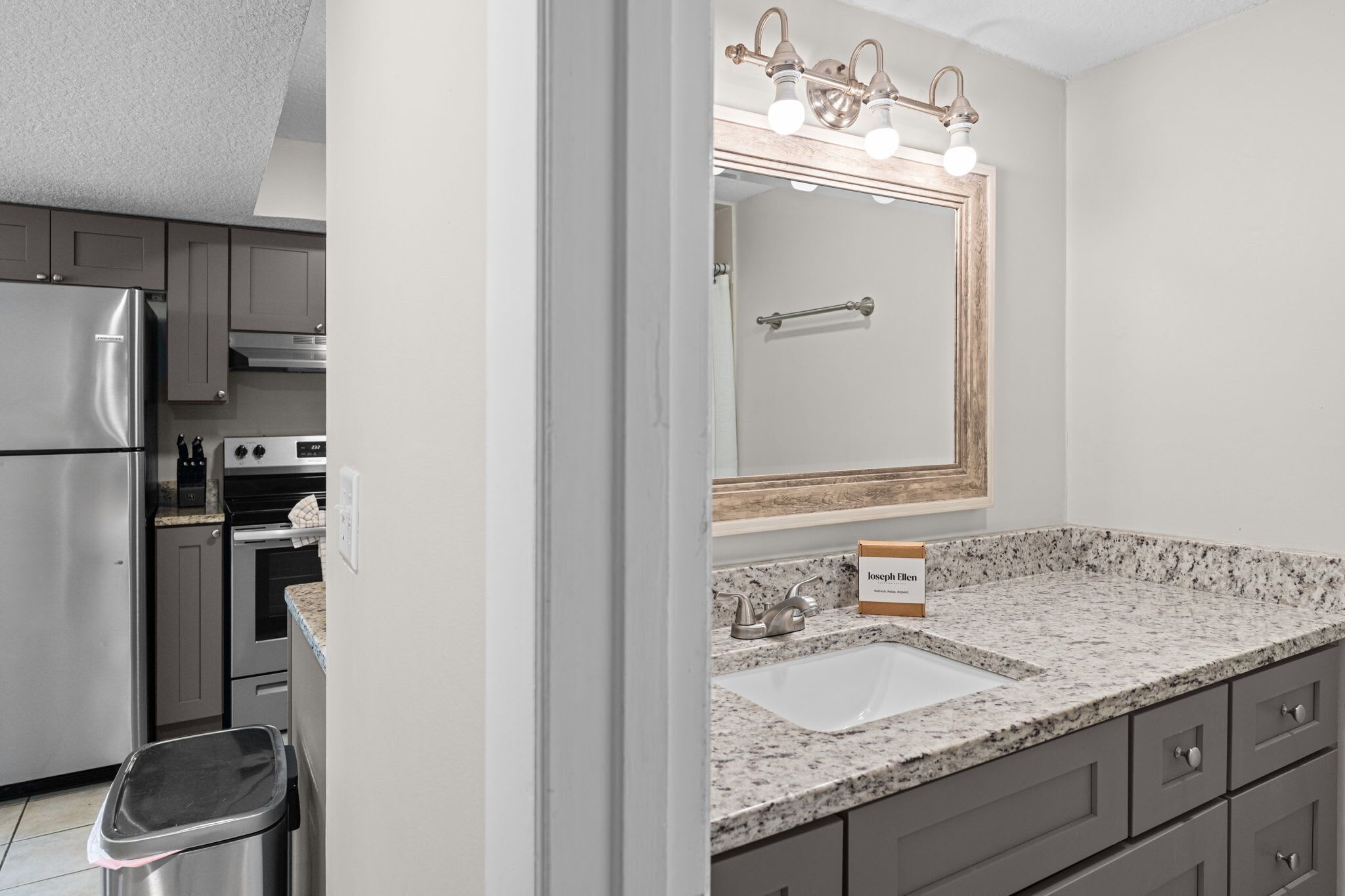A modern kitchen with stainless steel appliances, a granite countertop, and a built-in oven.