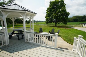 A covered outdoor area with a gazebo, picnic table, and chairs. - Black, White, & Barn w/ Hot Tub & Fire Pit (Fredericktown)