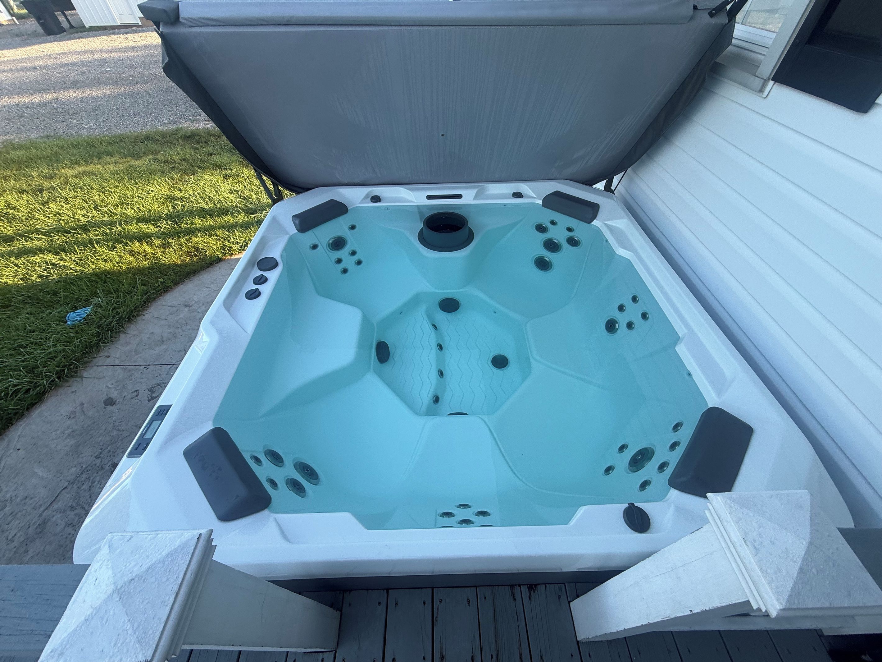 A hot tub with a hexagonal interior, positioned on a wooden deck.
