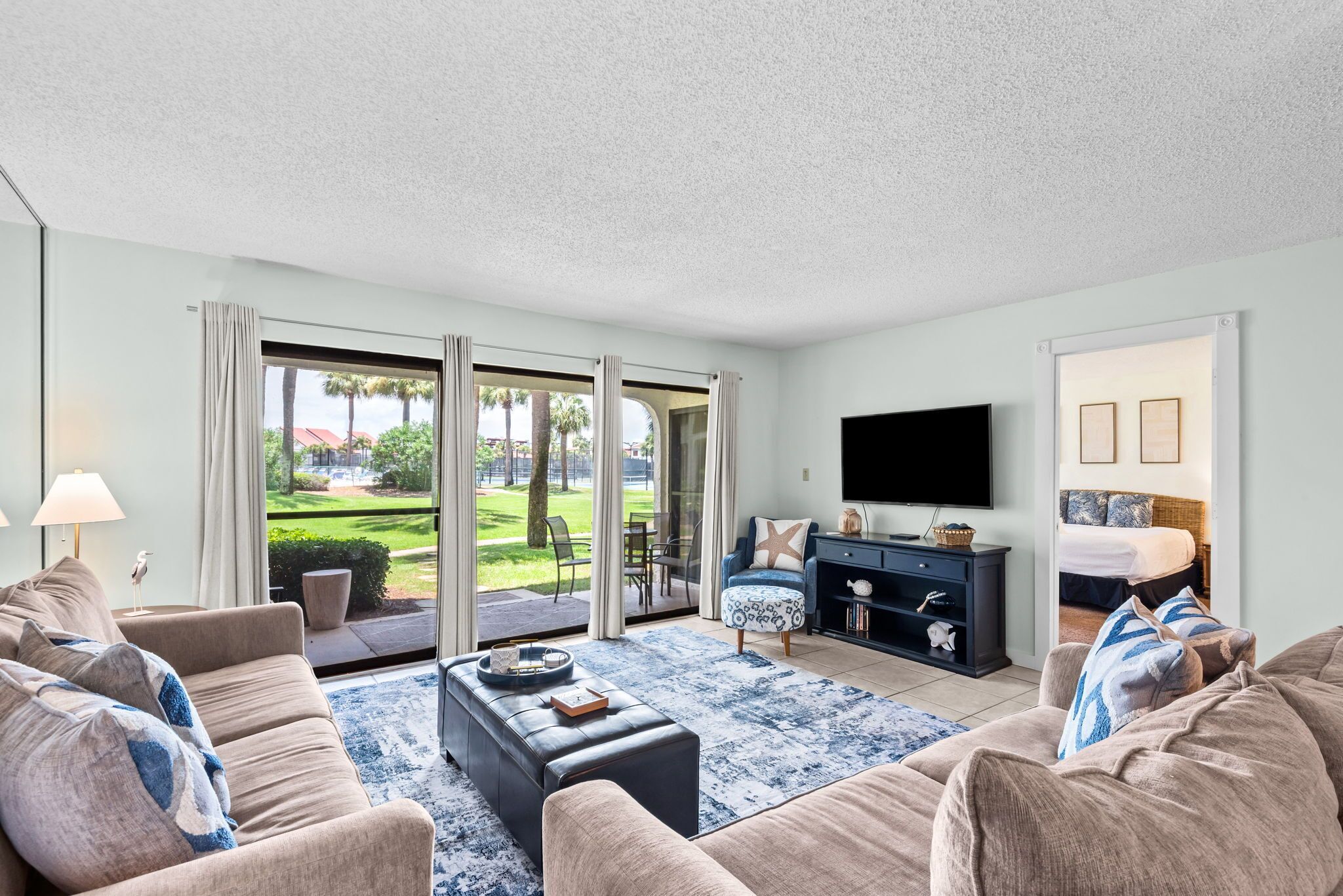 A modern living room with a sofa, coffee table, and TV.