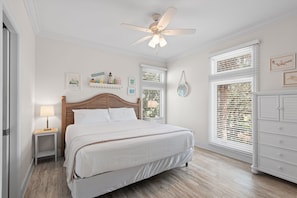 A bedroom with a bed, a nightstand, a lamp, a ceiling fan, and a dresser. - 5BR Gulf-front Home With Private Beach & Heated Pool - Sleeps 12 (Panama City Beach)