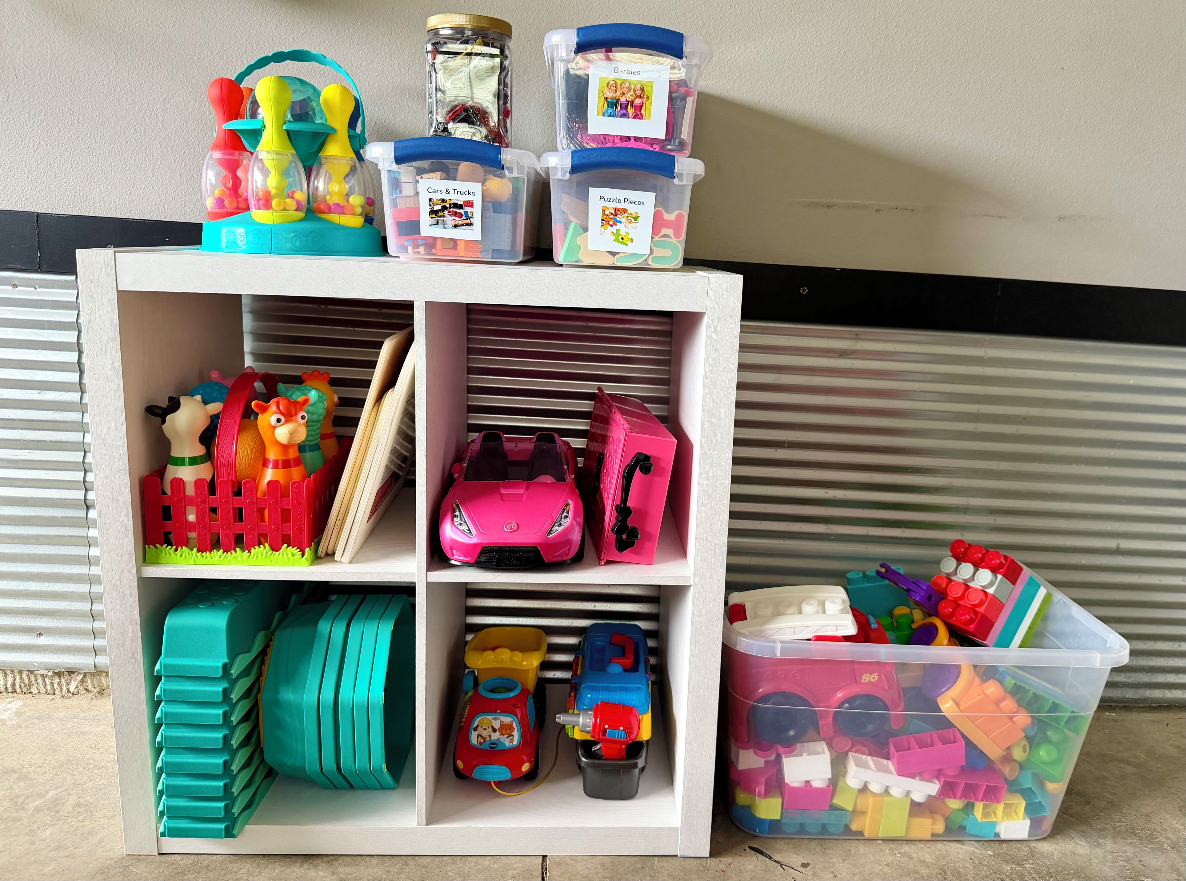 A storage unit with compartments for toys and puzzles.
