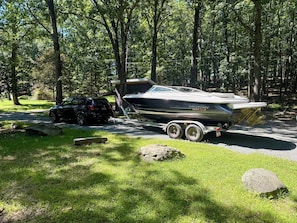 A boat on a trailer in a wooded area with a car nearby. - The Lake Haus, Boat-Friendly, Near Lake Wallenpaupack - Fire Pit • Dog-Friendly (Hawley)