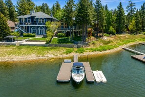 Una casa con un muelle y dos barcos.