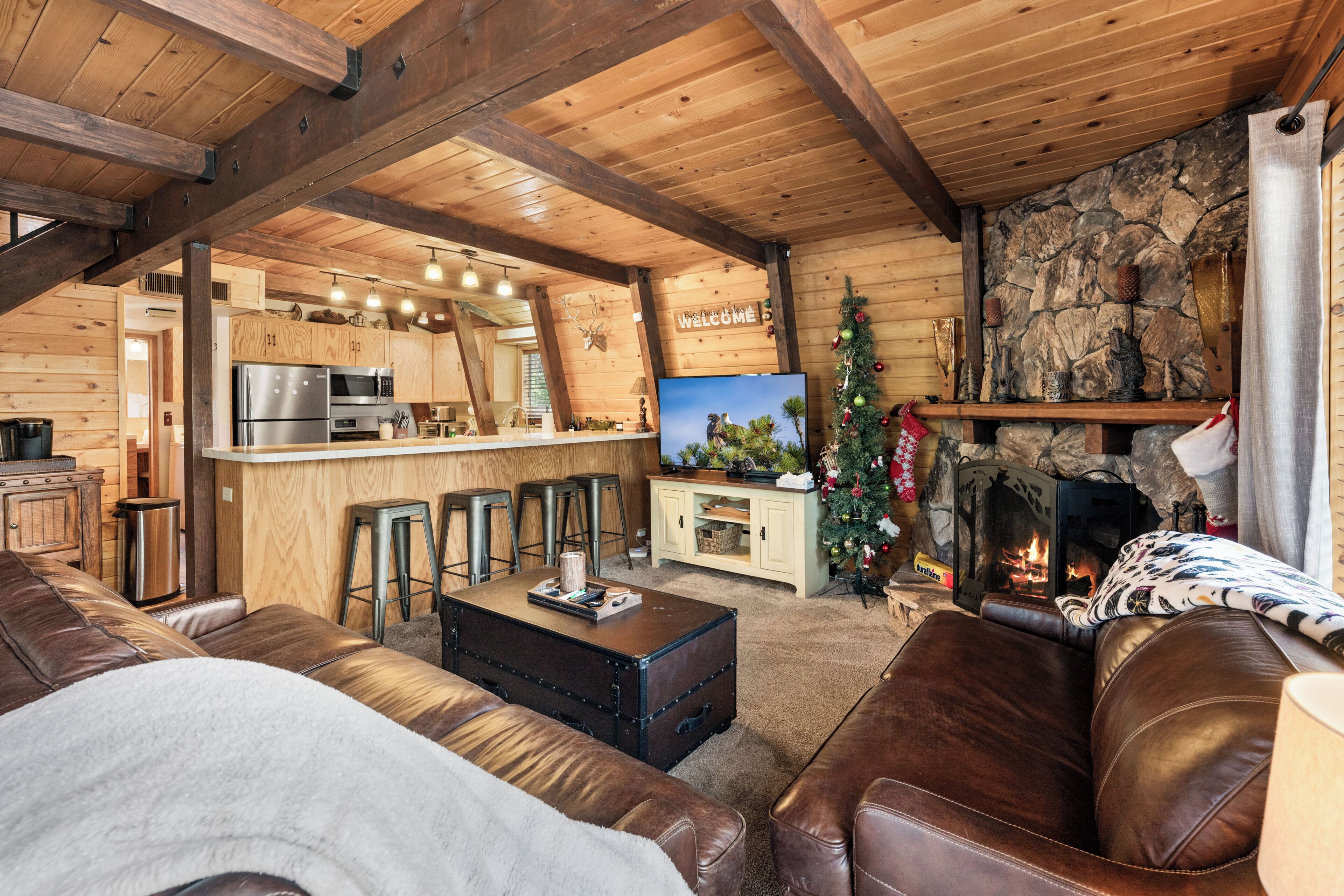 Un intérieur de chalet chaleureux comprenant une cuisine, un coin repas et un salon.