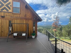 A wooden cabin with a deck, a bench, and a potted plant. - Vista Grande-2 Hot Tubs! 3 Large Decks! Arcade! (Ruidoso)