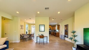 A spacious living area with a dining table, chairs, and a television. - Spacious 4BR Home  2 Living Rooms Near Disney (Hacienda Heights)