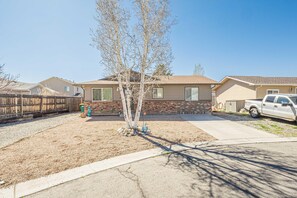 A residential property with a detached house, a driveway, a parked truck, and a small tree in the front yard. - Pedal Paradise II Cozy w/fenced yard (Fruita)