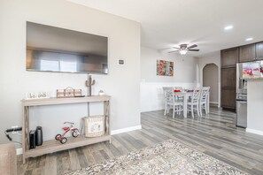 A modern kitchen with white cabinets, a built-in oven, and a refrigerator. - Pedal Paradise II Cozy w/fenced yard (Fruita)