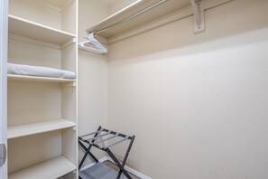A closet with open shelves and a hanging rack. - Pedal Paradise II Cozy w/fenced yard (Fruita)