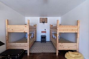 A room with two bunk beds, a small desk, a basketball hoop, and a suitcase. - Stargazing Dome Climbing Wall Zion & Bryce (Glendale)