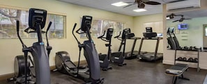 A gym with multiple exercise machines, a bench, and dumbbells. - 2-bedroom, 2-bathroom resort at Worldmark Kihei Hawaii (Kihei)