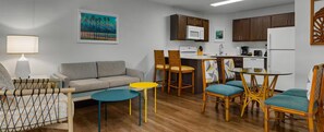 A compact living space with a sofa, a dining table with chairs, a kitchen area with a microwave, and a refrigerator. - 2-bedroom, 2-bathroom resort at Worldmark Kihei Hawaii (Kihei)