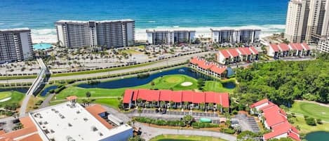 Ein Küstenresort mit mehreren Hochhäusern, einem Golfplatz und einer Marina.
