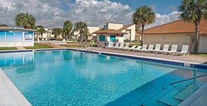 A swimming pool with lounge chairs and a lifeguard station. - Horizon South (Panama City Beach)