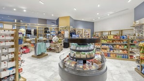 A retail store with clothing, accessories, and food items.