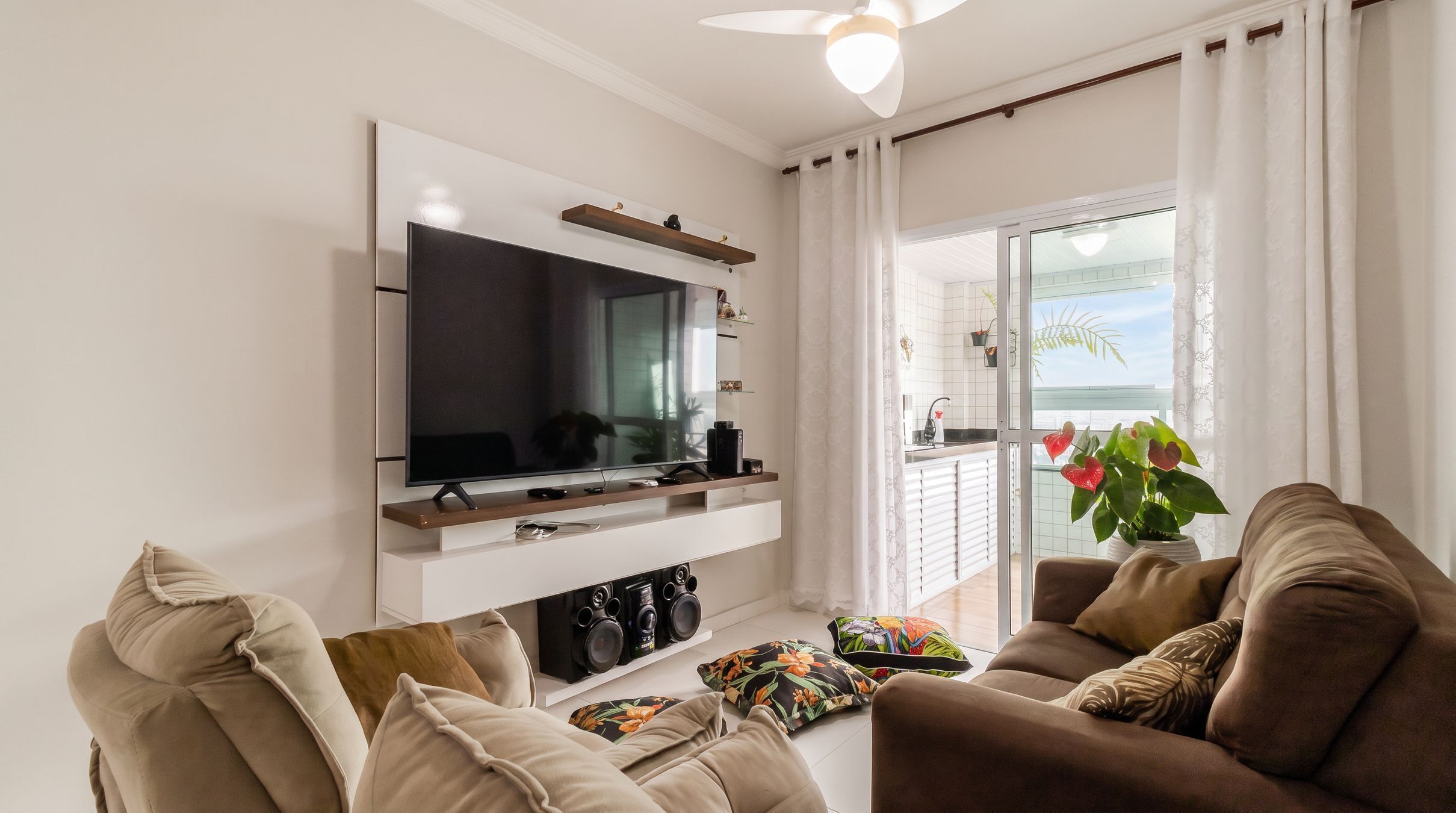 A modern living room with a flat-screen TV, a sofa, and a coffee table.