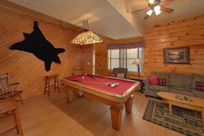 A pool table in a room with wooden walls, a ceiling fan, and a framed picture on the wall. - A Beary Happy Place | Hot Tub | Near Dollywood | Wooded Views (Pigeon Forge)