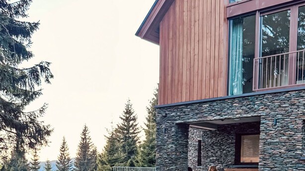 A modern building with a stone facade and a fire pit in the foreground. - Rebelka by Interhome (Horni Misecky)