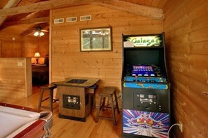 A wooden cabin with a pool table, a Galaga arcade machine, and a small stool. - Bearway to Heaven Cabin Rental (Wears Valley)