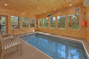 A wooden cabin with a pool, a paddle, and a chair. - Scenic Mountain Pool | Private Pool, Hot Tub, Near Dollywood, Game Room + Free Attraction Tickets (Pigeon Forge)