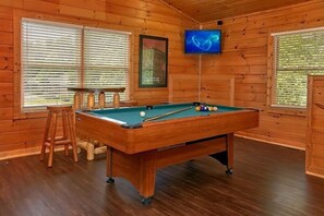 A pool table in a wooden room with a TV mounted on the wall. - Simply Irresistible | Theater, Hot Tub, Game Room, Pigeon Forge, Fireplace + Free Attraction Tickets (Pigeon Forge)