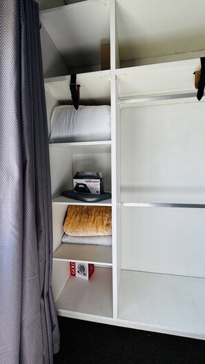 A storage unit with shelves, a mattress, and a box of bedding. - Experience Elevated Living in Dainfern's Panorama Suite (Johannesburg)