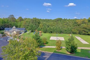 A residential area with a house, a basketball court, and a parking lot. - Mountain View 2504 Condo Suite (Pigeon Forge)