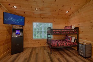 A bunk bed with a TV, a window with blinds, and a small cabinet. - A Beary Good Life | Hot Tub | Close to Tanger Outlets | Minutes from the Parkway (Sevierville)