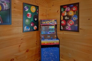 A pool table with a digital scoreboard in a wooden room. - Makin' Memories | Hot Tub, Game Room, Fire Pit, Fireplace + Free Attraction Tickets (Sevierville)