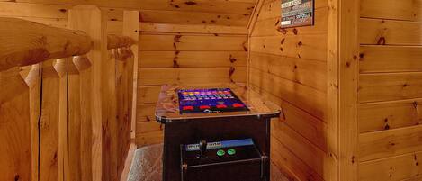 A wooden cabin interior with a small table featuring a video game console.