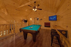 A pool table with balls, a ceiling fan, and a television mounted on the wall. - Swimming in the Smokies | Indoor Pool, Hot Tub, Game Room, Sleeps 12 + Free Attraction Tickets (Pigeon Forge)