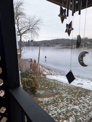 A view of a frozen lake from a window with star and crescent decorations.