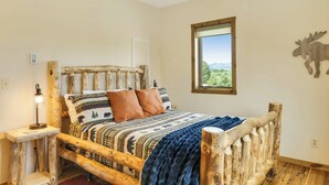 A rustic wooden bed with a view of the outdoors through a window. - 360 Mtn Views Close to Mt Princeton Hot Springs (Nathrop)