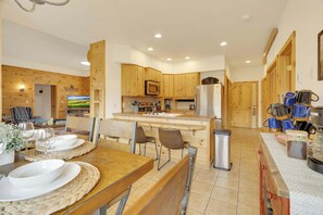 A modern kitchen with wooden cabinets, a stainless steel refrigerator, and a built-in oven. - 360 Mtn Views Close to Mt Princeton Hot Springs (Nathrop)