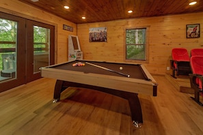 A pool table with balls, a Super Mario-themed mirror, and red chairs in a room with wooden walls and ceiling. - Smoky Mountain Splash | Private Pool, Theater, Hot Tub, Game Room + Free Attraction Tickets (Sevierville)