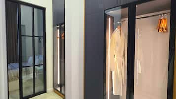 A hotel room with a large mirror, a sliding glass door closet, and a bed with a view of the outside.