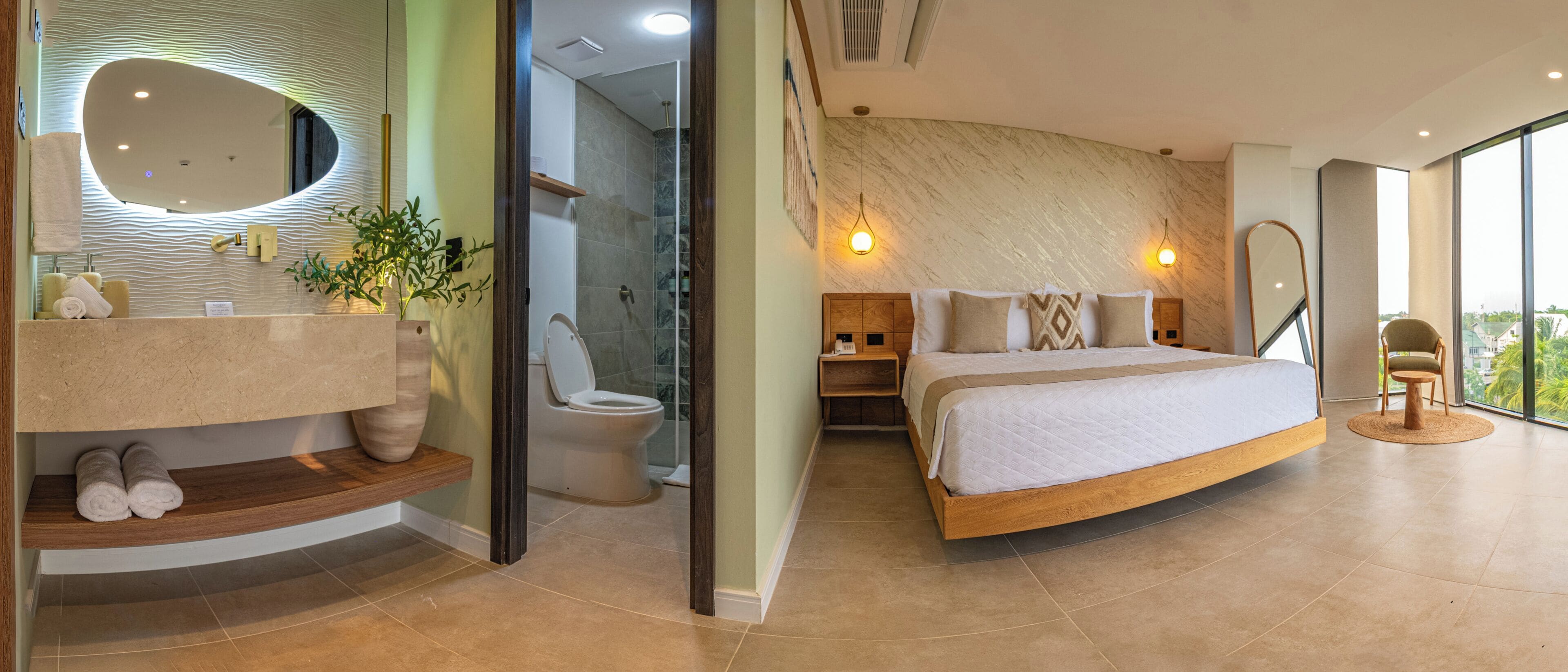 A modern bathroom with a curved vanity, a shower, and a large mirror.