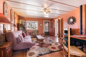 A cozy living room with a sofa, a coffee table, and a rug.