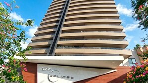 A high-rise hotel with a modern design, featuring a prominent Sky Eclipse sign at the base.