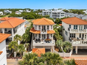 A residential area with multiple two-story houses featuring red-tiled roofs and balconies. - 5BR 30A Beach House Private Beach Access - Sleeps 10 (Santa Rosa Beach)
