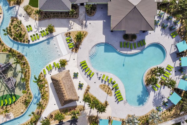 A resort with multiple swimming pools, sun loungers, and a central building. - Stay in Style! 6BR Storey Lake Retreat with Pool & Spa (Kissimmee)