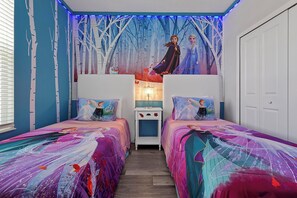 A bedroom with two beds, a wall mural, and a nightstand. - Stay in Style! 6BR Storey Lake Retreat with Pool & Spa (Kissimmee)