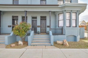 A two-story house with a front porch, two doors, and a small garden with a tree. - Apartment in Historic Downtown Prescott - Fremont Room (Prescott)