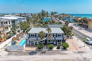 A beachfront hotel with a pool, multiple balconies, and a view of the ocean. - Seagrass Shores Unit 3 (Bradenton Beach)