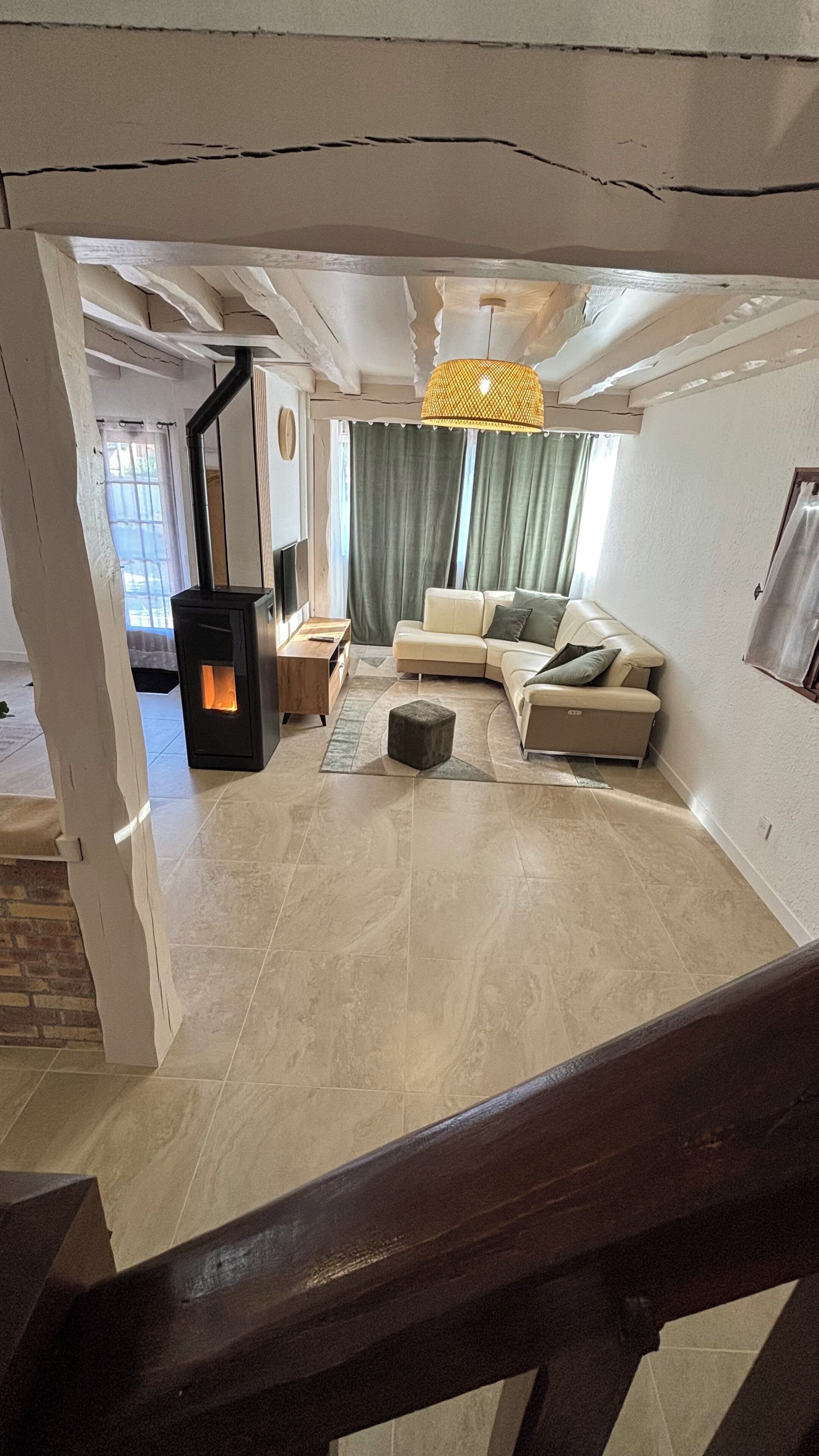 A living room with a sofa, a small table, a rug, and a fireplace.